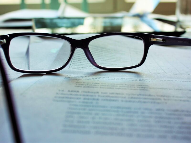 cancel arbitration agreement -- papers on a desk with pair of glasses on top of them