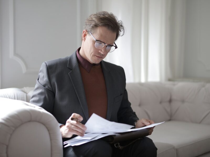 nursing home arbitration agreement -- man sitting on sofa reviewing paperwork